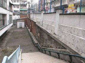 Photo 1: the original granite plinths and pillars of the fenced walls along Staunton Street and Aberdeen Street