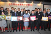 Secretary for Development, Mrs Carrie Lam, and Chairman of the Advisory Committee on Revitalisation of Historic Buildings, Mr Bernard Chan, take a group photo with successful applicants of the buildings included under Batch I of the Revitalising Historic Buildings Through Partnership Scheme and members of the Advisory Committee at the press conference on February 17.