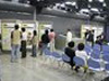 participants looking at display panels and the model of the Central School