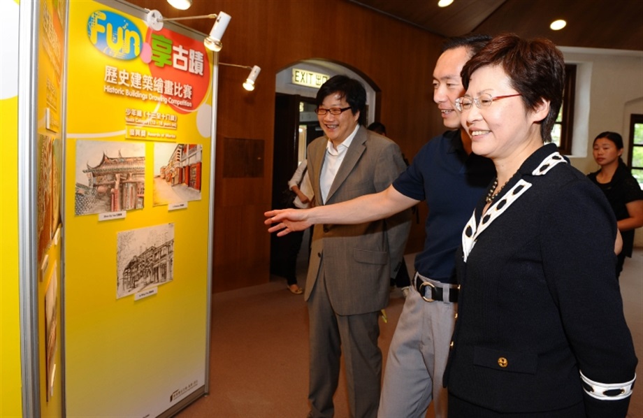 The Secretary for Development, Mrs Carrie Lam, together with Chairman of the Antiquities Advisory Board, Mr Bernard Chan (centre), and Commissioner for Heritage, Mr Jack Chan (left), touring around the exhibition boards on the winning entries of the drawing competition.