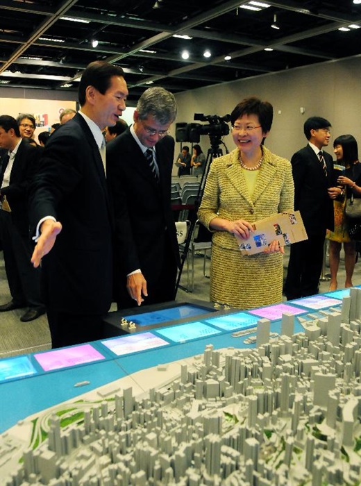 The Secretary for Development, Mrs Carrie Lam, and Chairman of the Antiquities Advisory Board, Mr Bernard Chan, view a model showing the heritage buildings in Central District after attending a briefing session on "Conserving Central".