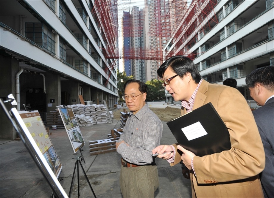 Mr Tsang is being briefed by officials of the Development Bureau and CreateHK on the revitalisation plan of the former Police Married Quarters on Hollywood Road.