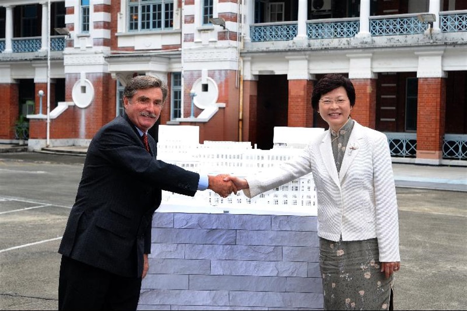 The Secretary for Development, Mrs Carrie Lam, and Chairman of the Hong Kong Jockey Club, Mr T Brian Stevenson, unveil a model showing the revised design for the Central Police Station Compound today (October 11).