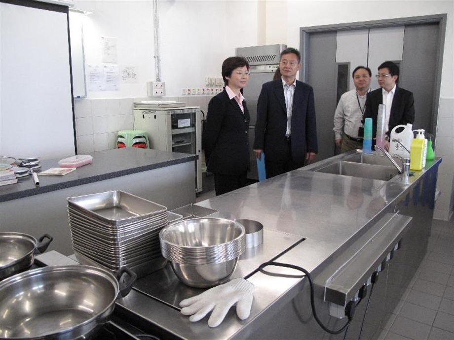 The Secretary for Development, Mrs Carrie Lam, visits the kitchen used for cooking classes at the Tuen Mun Children and Juvenile Home.