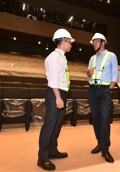 The Secretary for Development, Mr Michael Wong (right), visited Central and Western District today (August 29) to inspect the progress of works for the revitalisation of the Central Police Station Compound. Picture shows Mr Wong visiting a new building of the revitalisation project, which will be used as a multi-purpose auditorium, and being briefed by the Executive Director of Charities and Community of the Hong Kong Jockey Club, Mr Cheung Leong (left), on the progress of works.