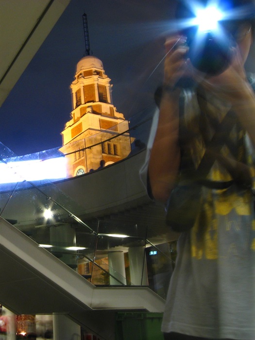 30 Merit Awards<br>Lau Shing Lai<br>Building: Former Kowloon-Canton Railway Clock Tower<br>Grading: Declared Monument<br>Artist's statement: This photos was shot in front of clock tower. There is a new construct which mean new century. The boy who was taking the photo means everybody in the coming century will still notice the clock tower. The stars mean the clock tower will continue shine in the future.